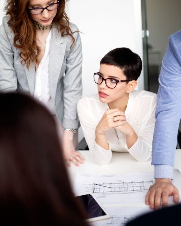 group-of-lawyers-discussing-contract-together-in-VCQ74WN.jpg